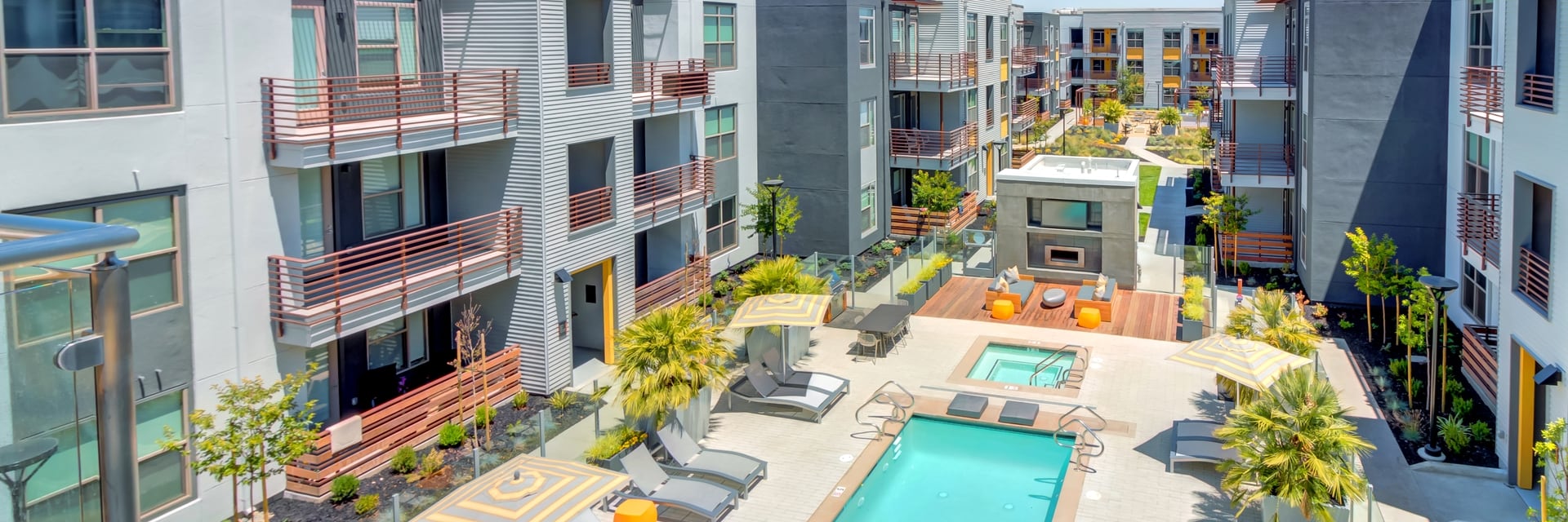 Menlo Park CA Apartments - Resort Style Swimming Pool Surrounded by Various Shaded Lounge Chairs